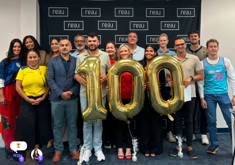 Real Edge Network members celebrating a milestone at a Real Brokerage office.